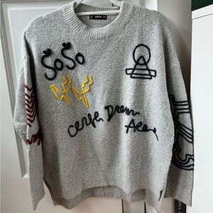 Soft oversized grey sweater with color details